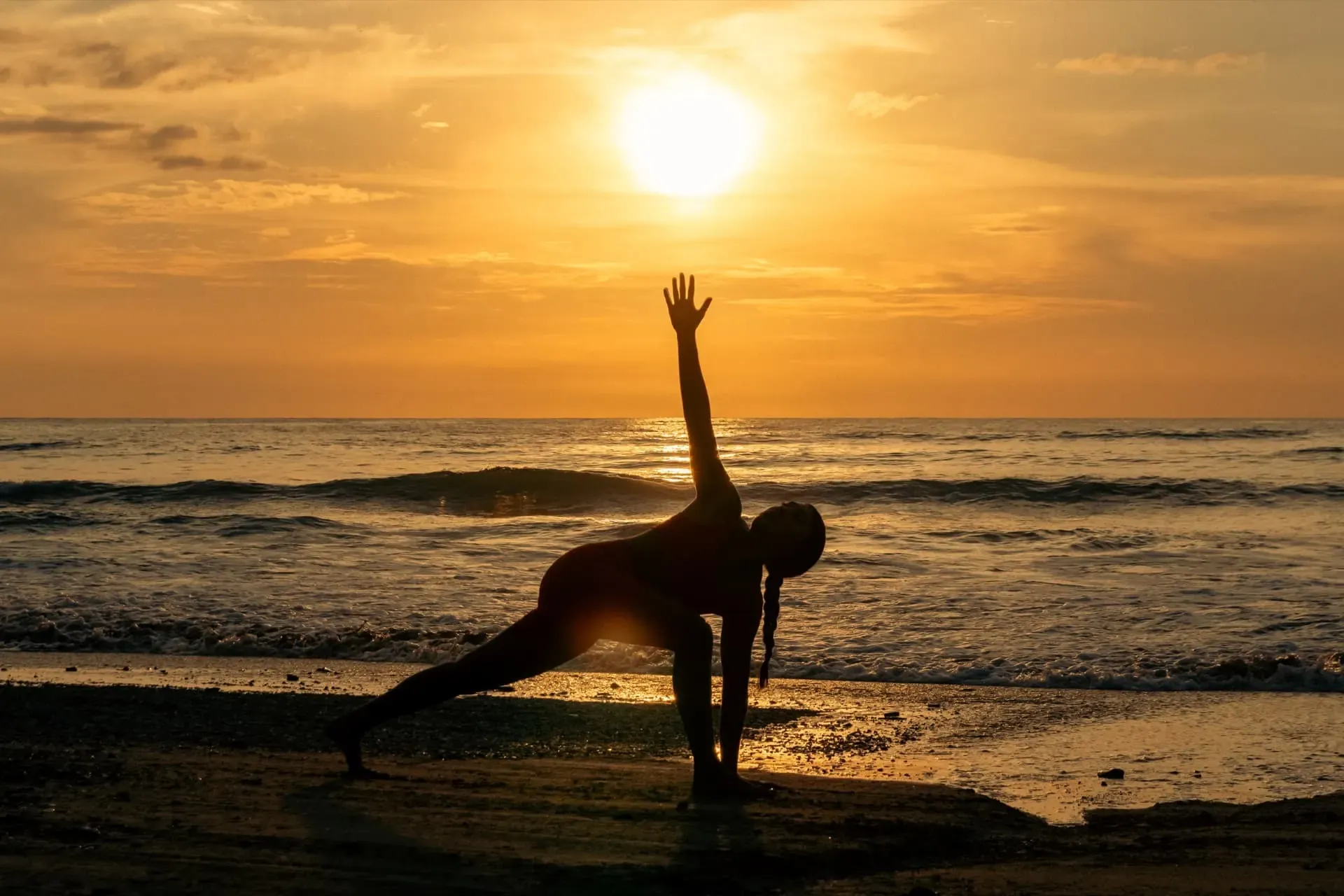 Yoga pose on the beach at sunset